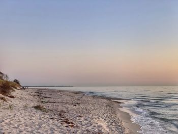 Scenic view of sea against clear sky during sunset