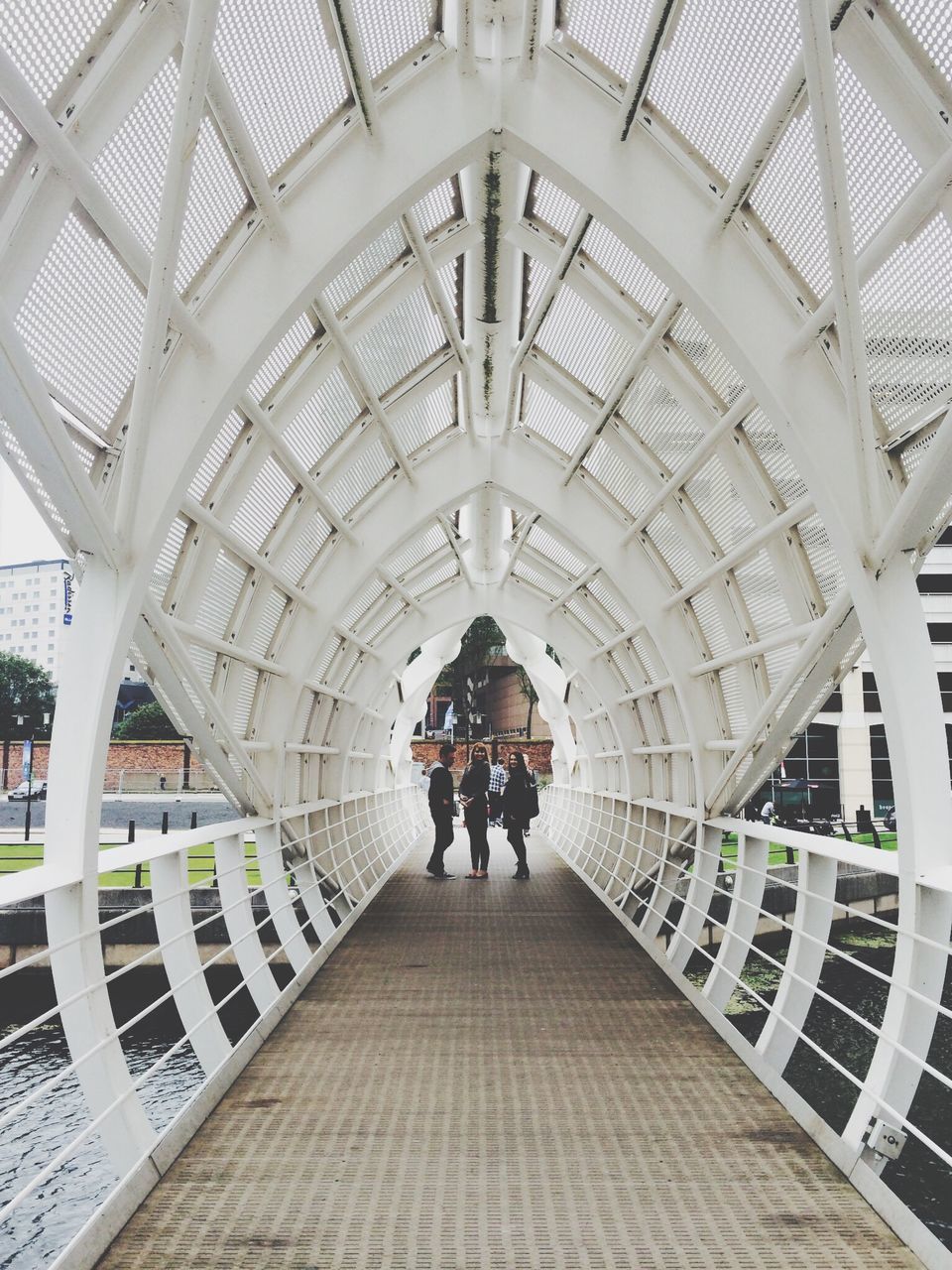 indoors, architecture, the way forward, built structure, ceiling, men, lifestyles, rear view, walking, full length, arch, diminishing perspective, person, leisure activity, railing, vanishing point, travel, day