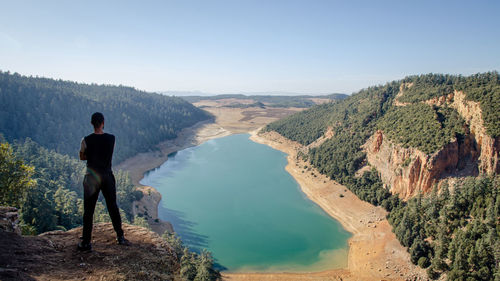 Hiking man looking at aguelmam azigza lake 