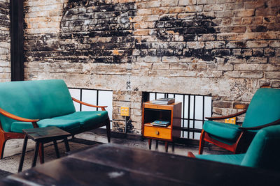 Empty chairs and tables against wall