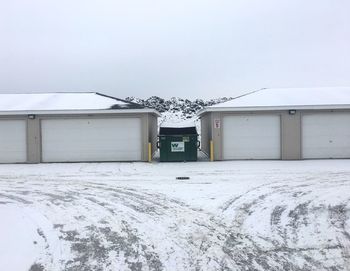 Snow covered built structure against clear sky