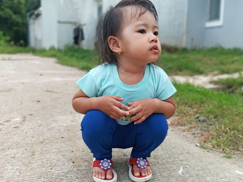 Cute girl sitting outdoors