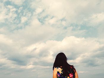 Silhouette of woman against cloudy sky
