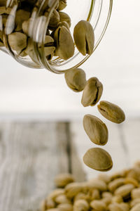Close-up of pistachio falling from jar