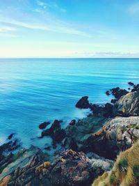 Scenic view of sea against blue sky