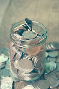 Close-up of coins in jar on table