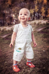 Portrait of cute girl standing on field