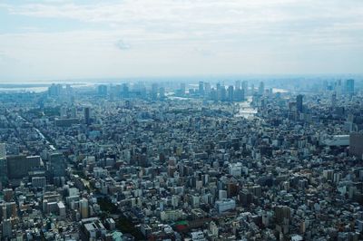 Aerial view of crowded cityscape against sky