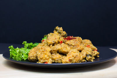Close-up of food on table against black background