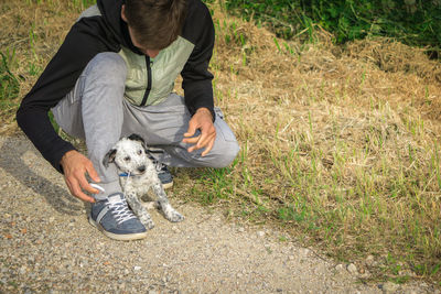 Full length of man playing with puppy