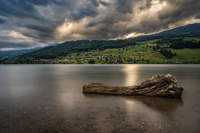 Scenic view of lake and mountains against sky