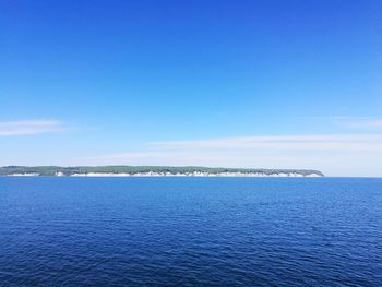 Scenic view of sea against blue sky