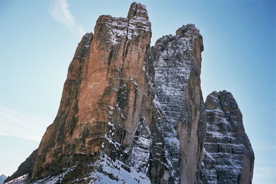 Low angle view of rock formation against sky