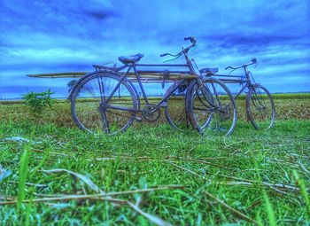 Bicycle on field against sky