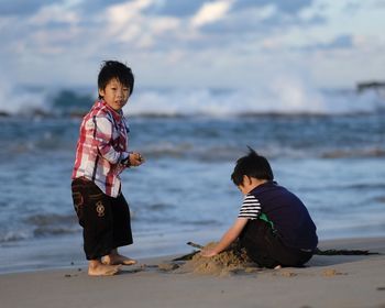 Siblings playing at beach