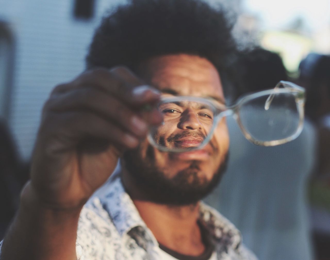 headshot, front view, one man only, portrait, one person, men, looking at camera, adults only, only men, eyeglasses, holding, close-up, mature adult, indoors, eyesight, adult, day, people, smiling, improvement, human body part