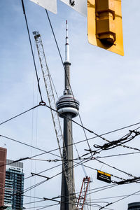 Low angle view of electricity pylon against sky