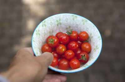 Close-up of hand holding strawberry