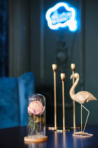 Stylish statuette of flamingo and rose in a glass jar