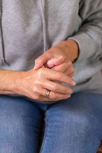 Senior woman suffering from hand and finger joint pain and inflammation. rheumatoid arthritis, gout.