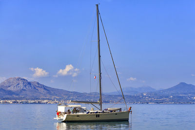 Sailboat sailing on sea against sky