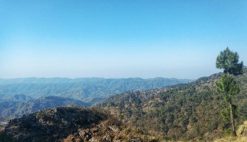 Scenic view of mountains against clear blue sky