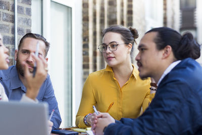 Business people discussing in office balcony