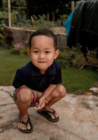 Portrait of cute boy standing in park