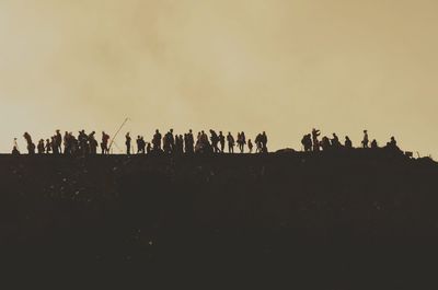 Silhouette of people against clear sky