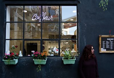 Woman with flowers on window