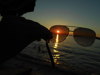 Cropped image of man against sky at sunset