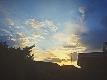 Low angle view of built structure against sky at sunset