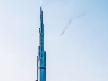 Low angle view of smoke stack against sky