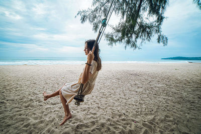 Side view of young woman on beach