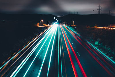 High angle view of light trails on road at night