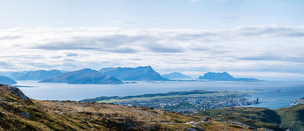 Scenic view of sea and mountains against sky