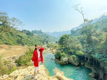 Man standing on mountain against sky