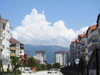 Street amidst buildings in town against sky