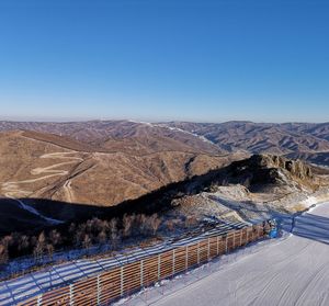Scenic view of mountains against clear blue sky