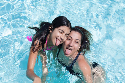 Portrait of a smiling young woman swimming in pool