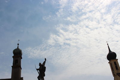 Low angle view of silhouette statue against sky