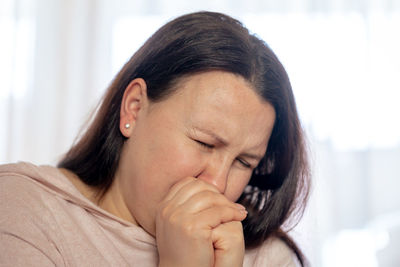 Close-up of woman having ear ache