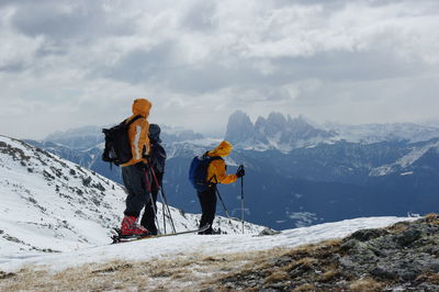 People standing on snowcapped mountain