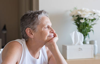 Close-up of woman sitting at home