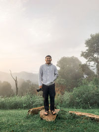 Full length of man standing on land against sky