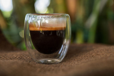 Close-up of coffee in glass on table