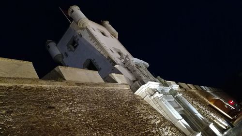 Low angle view of sculpture against sky at night