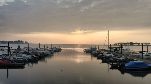 Boats in marina at sunset