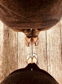 Low section of woman standing on wood