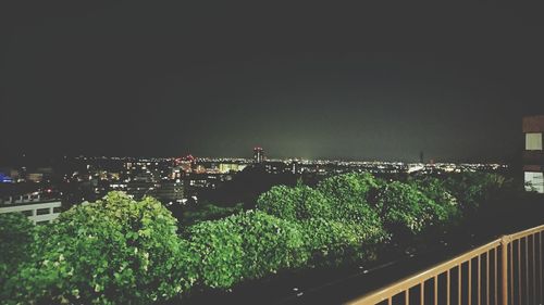 High angle view of illuminated city against clear sky